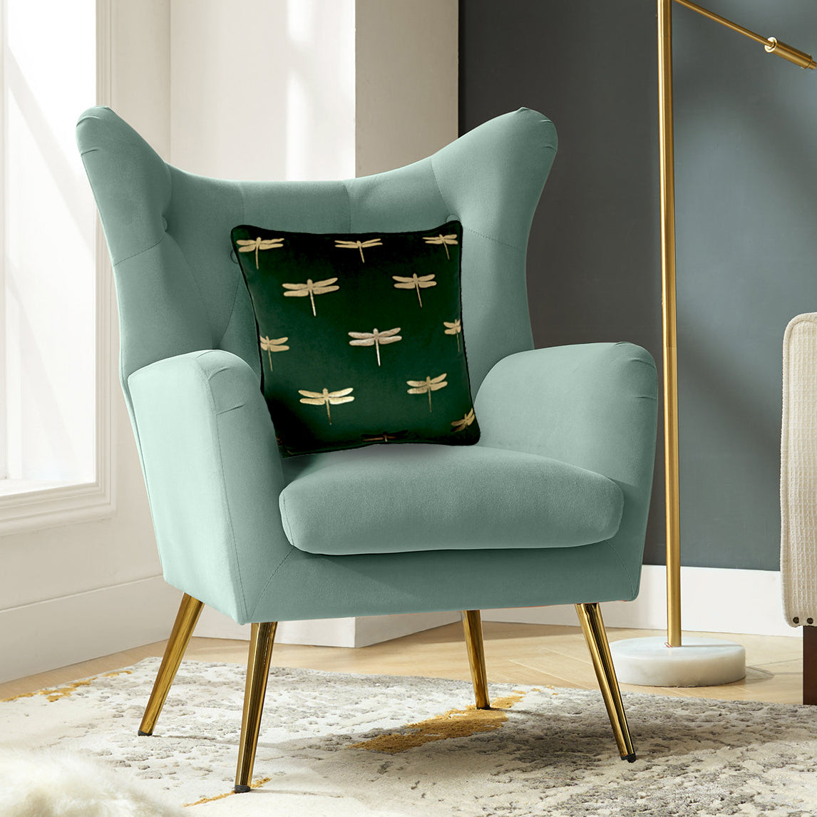 Dragonfly foil print velvet cushion cover in dark green styled on a sofa